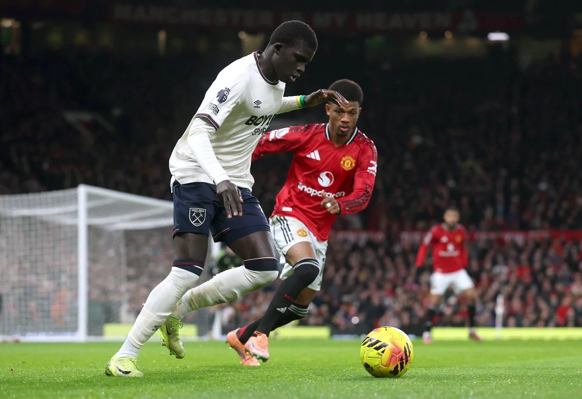 El Hadji Malick Diouf of West Ham United is put under pressure by Amad Diallo of Manchester United during the Premier League match between Manchester United and West Ham United