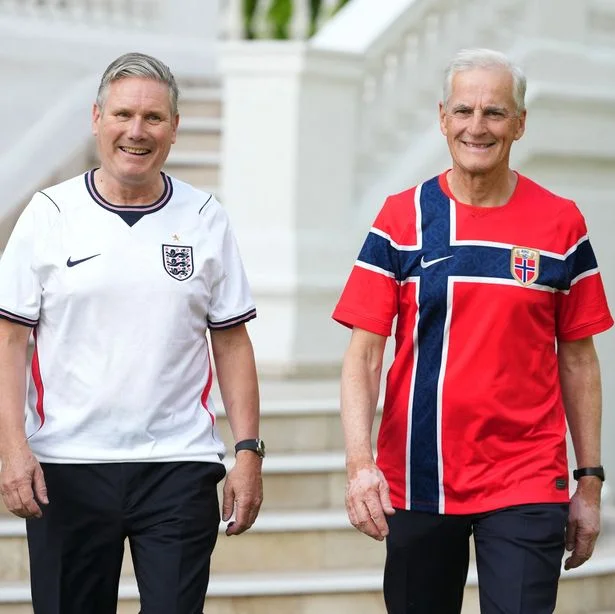 Britain's Prime Minister Keir Starmer (L) and Norway's Prime Minister Jonas Gahr Store (R) walk in the grounds of the British Embassy wearing their national football teams soccer jerseys ahead of a meeting on the sidelines of the NATO summit, in Ankara on July 7, 2026