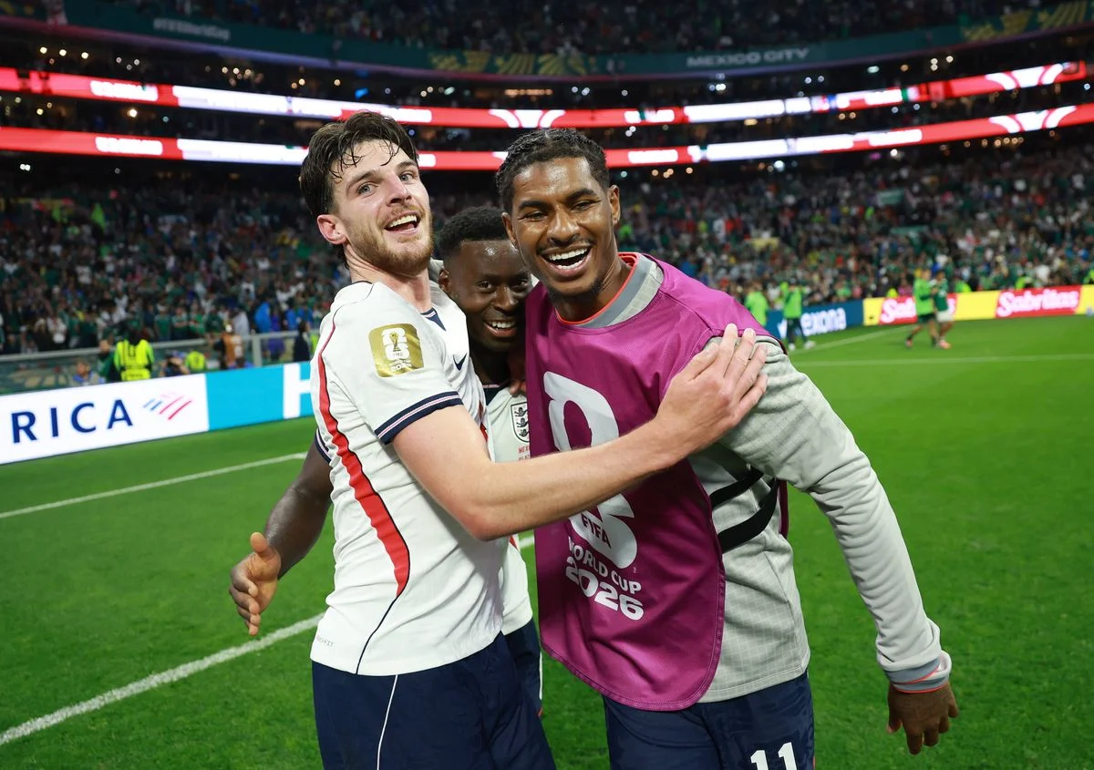 Declan Rice, Marcus Rashford and Marc Guehi celebrate after the team's 3-2 victory during the FIFA World Cup 2026 Round of 16 match between Mexico and England. 