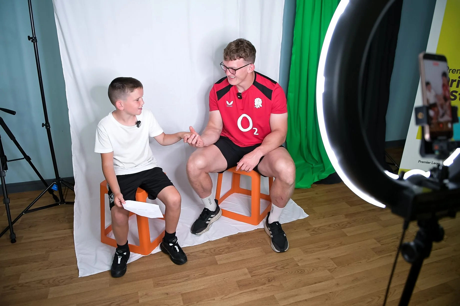 England rugby union international Ted Hill joins a child for a creative studio activity