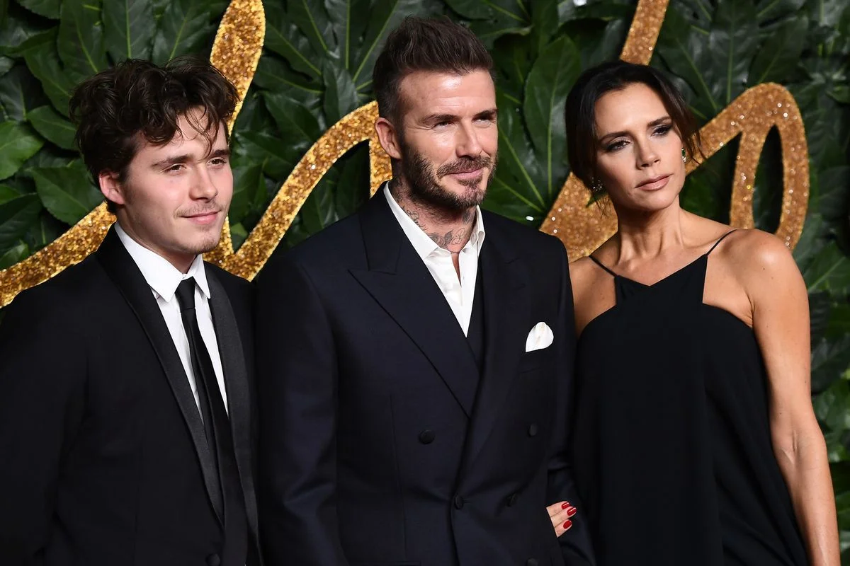 Brooklyn Beckham, David Beckham and Victoria Beckham photographed back in 2018 in happier times