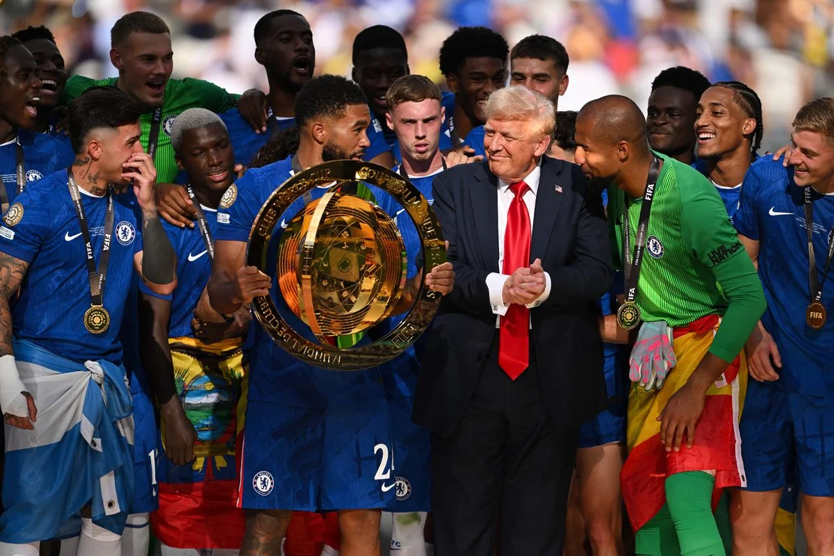 Donald Trump stands with Chelsea players after they won the Club World Cup