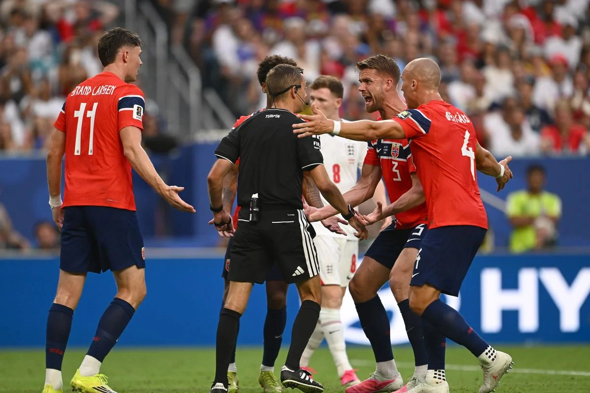 Referee Clement Turpin prepares to issue a yellow card to Kristoffer Ajer during England's World Cup win over Norway